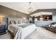 Spacious main bedroom featuring a vaulted ceiling, pendant lighting, and attached ensuite at 10258 Pennington Ln, Highlands Ranch, CO 80126