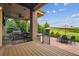 Outdoor kitchen with stone facade, built-in grill, bar seating, and multiple tables for gathering at 10258 Pennington Ln, Highlands Ranch, CO 80126