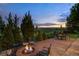 Enjoy outdoor living with a stone patio, fire pit, dining set, and stunning sunset vistas at 10258 Pennington Ln, Highlands Ranch, CO 80126