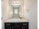Clean bathroom with a modern vanity, featuring dark wood cabinets and a large mirror at 1732 Aspen Meadows Cir, Federal Heights, CO 80260