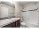 Full bathroom featuring a white vanity and a shower-tub combo with white tile at 1732 Aspen Meadows Cir, Federal Heights, CO 80260