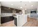 Modern kitchen featuring dark wood cabinets, stainless steel appliances, and a convenient breakfast bar at 1732 Aspen Meadows Cir, Federal Heights, CO 80260