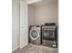 Laundry room with a gray washer and dryer set and a white door at 1732 Aspen Meadows Cir, Federal Heights, CO 80260