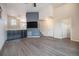 Spacious living room with modern gray floors, a stylish accent wall, and ample natural light at 1732 Aspen Meadows Cir, Federal Heights, CO 80260