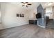 Open-concept living room with wood-look floors, a stylish accent wall, and convenient access to the kitchen at 1732 Aspen Meadows Cir, Federal Heights, CO 80260