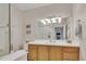 Well-lit bathroom with a large mirror, wood vanity, and glass-enclosed shower at 2700 E Cherry Creek South Dr # 220, Denver, CO 80209
