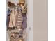 Organized closet with hanging clothes, shoes, and storage shelves at 2700 E Cherry Creek South Dr # 220, Denver, CO 80209