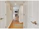 Hallway with hardwood floors leading to a cozy living area with a fireplace at 2700 E Cherry Creek South Dr # 220, Denver, CO 80209