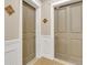 Hallway with neutral-toned walls, stylish doors, and decorative accents, creating a welcoming entrance at 2700 E Cherry Creek South Dr # 220, Denver, CO 80209