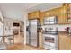 Spacious kitchen with stainless steel appliances adjacent to a cozy living area with a fireplace at 2700 E Cherry Creek South Dr # 220, Denver, CO 80209
