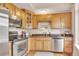 Well-equipped kitchen with stainless steel appliances, granite countertops, and warm wood cabinetry at 2700 E Cherry Creek South Dr # 220, Denver, CO 80209