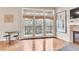 Bright living room with hardwood floors, fireplace, and access to balcony with serene views at 2700 E Cherry Creek South Dr # 220, Denver, CO 80209
