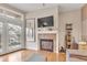 Cozy living room with fireplace, flat screen TV, and balcony offering scenic views at 2700 E Cherry Creek South Dr # 220, Denver, CO 80209