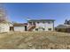 Expansive backyard with wood shed, basketball hoop, and elevated wood deck on a two-story home at 10932 W 107Th Ave, Broomfield, CO 80021