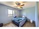 Cozy bedroom with a comfortable bed and a window offering natural light and outdoor views at 10932 W 107Th Ave, Broomfield, CO 80021