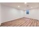 Finished basement room with luxury vinyl flooring, a window, and recessed lighting at 1325 Lima St, Aurora, CO 80010