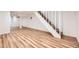 Spacious basement featuring luxury vinyl flooring and a staircase with white painted risers at 1325 Lima St, Aurora, CO 80010