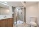 Bathroom featuring a corner shower, sink, and toilet at 1325 Lima St, Aurora, CO 80010