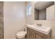 Bathroom features a vanity sink, toilet, small window, and tiled shower at 1325 Lima St, Aurora, CO 80010