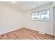 Clean, bright bedroom featuring hardwood floors, recessed lighting, and a large double-pane window at 1325 Lima St, Aurora, CO 80010