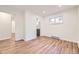 Bedroom featuring an ensuite bath, hardwood floors, and a large window at 1325 Lima St, Aurora, CO 80010