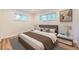 Bedroom featuring a nicely made bed, marble nightstands, and a window at 1325 Lima St, Aurora, CO 80010
