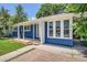 Inviting blue house facade, featuring a cozy covered porch and well-kept lawn for relaxed curb appeal at 1325 Lima St, Aurora, CO 80010