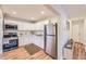 Modern kitchen with stainless steel appliances, sleek white cabinets, and a clean, contemporary design at 1325 Lima St, Aurora, CO 80010