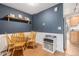 Cozy dining area with wooden table, hardwood floors, and stylish blue accent wall with shelving at 1885 S Quebec Way # C15, Denver, CO 80231