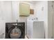 Functional laundry room with a modern dryer, a washing machine, and a neutral color scheme at 1885 S Quebec Way # C15, Denver, CO 80231