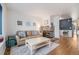 Cozy living room with stone fireplace, leather sofa, hardwood floors, and bright, neutral decor at 1885 S Quebec Way # C15, Denver, CO 80231