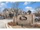 Community sign at Topaz at Indian Creek, set in a brick surround with manicured landscaping at 1885 S Quebec Way # C15, Denver, CO 80231