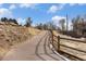 Scenic walking path with natural wood fence leading to homes in a tranquil, natural setting at 1885 S Quebec Way # C15, Denver, CO 80231