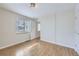 Bright bedroom with light wood floors, window with blinds, and neutral decor at 3420 Tennyson St # 105, Denver, CO 80212