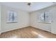 Bedroom featuring light wood floors, windows with blinds, and a modern light fixture at 3420 Tennyson St # 105, Denver, CO 80212