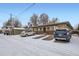 Brick building with a parking area covered in snow at 3420 Tennyson St # 105, Denver, CO 80212