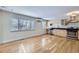 Bright kitchen with stainless steel appliances, wood floors and a large window at 3420 Tennyson St # 105, Denver, CO 80212