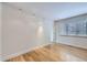 Bright living room with light wood floors, large window and baseboard trim at 3420 Tennyson St # 105, Denver, CO 80212