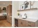 Chic bar area featuring custom cabinets, a wine fridge, and stylish decor at 6196 Oxford Peak Ln, Castle Rock, CO 80108