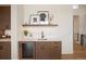 Elegant bar area features custom cabinets, a wine fridge, and stylish decor at 6196 Oxford Peak Ln, Castle Rock, CO 80108