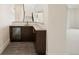 Basement bar area with custom cabinets, tile floor, and beverage fridge at 6196 Oxford Peak Ln, Castle Rock, CO 80108