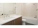 Elegant bathroom with a modern vanity, bathtub with shower, and stylish fixtures, creating a relaxing space at 6196 Oxford Peak Ln, Castle Rock, CO 80108