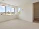 Well-lit bedroom with a large window, a walk-in closet, and neutral carpeting creating a cozy atmosphere at 6196 Oxford Peak Ln, Castle Rock, CO 80108