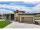 Beautiful home with modern architecture, three-car garage, and manicured lawn at 6196 Oxford Peak Ln, Castle Rock, CO 80108