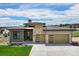 Modern home with a three-car garage, stone accents, and pristine landscaping at 6196 Oxford Peak Ln, Castle Rock, CO 80108