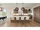 Spacious kitchen featuring a large island, stainless steel appliances, and stylish pendant lighting at 6196 Oxford Peak Ln, Castle Rock, CO 80108
