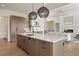 Modern kitchen showcasing a large island, stainless steel appliances, and stylish pendant lighting at 6196 Oxford Peak Ln, Castle Rock, CO 80108