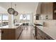 Well-lit modern kitchen with stainless steel appliances, ample cabinetry, and an adjacent dining area at 6196 Oxford Peak Ln, Castle Rock, CO 80108
