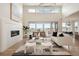Stylish living room with modern fireplace, hardwood floors, and access to the outdoor space at 6196 Oxford Peak Ln, Castle Rock, CO 80108