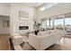 Bright living room with fireplace, hardwood floors, and access to balcony at 6196 Oxford Peak Ln, Castle Rock, CO 80108